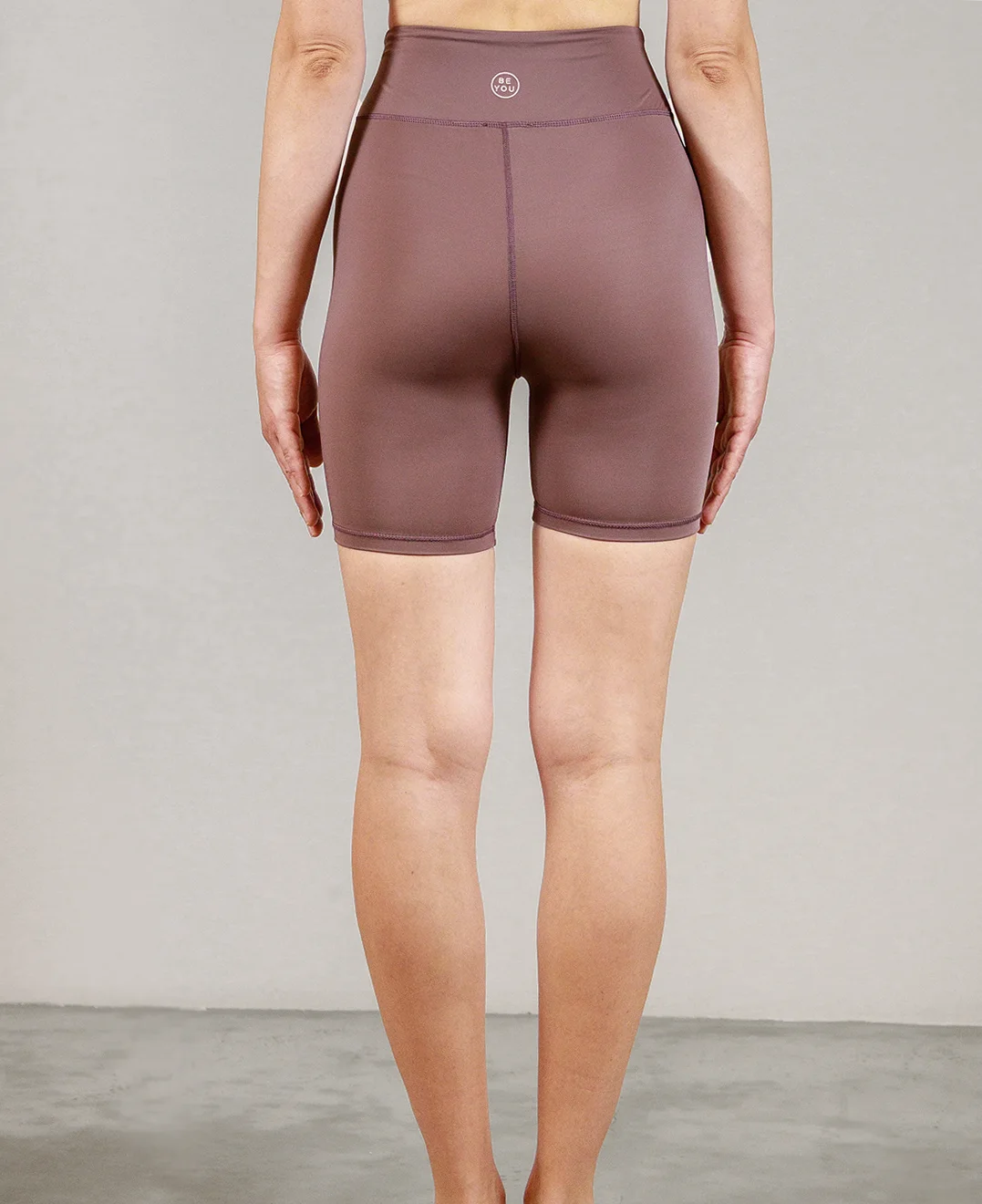 Giovane modella indossa ciclista per Pilates Infinity, color maple, della linea di abbigliamento Be You Firenze